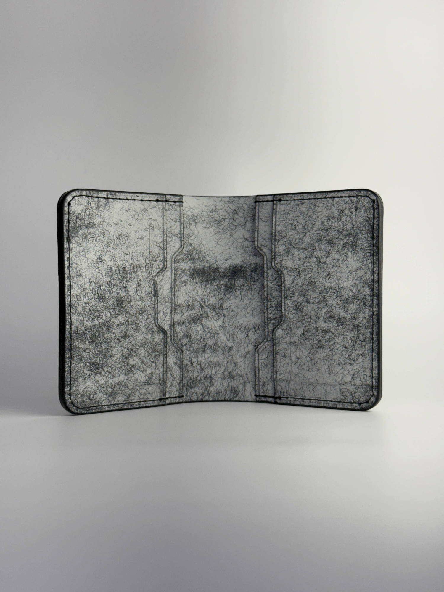 black glance leather wallet opened front side view, on a white background