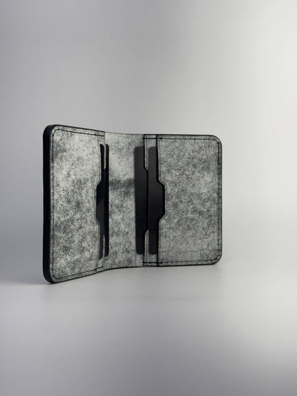 black glance leather wallet opened front side view with cards, on a white background