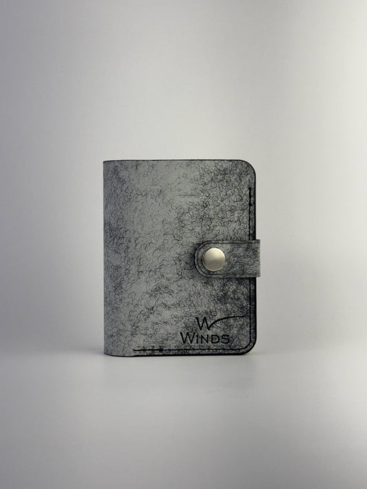 black glance leather wallet with button closure, front side view, on a white background
