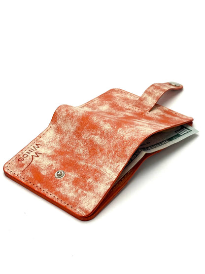 orange glance bifold wallet with strap, opened back view with cash and Winds logo
