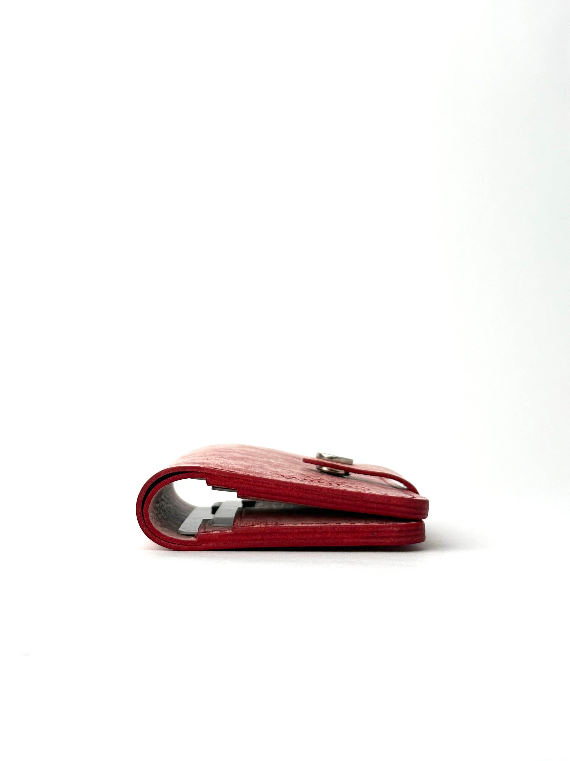 red glance leather wallet with strap, closed edge view lying and closed