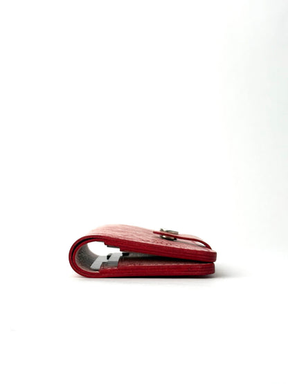 red glance leather wallet with strap, closed edge view lying and closed