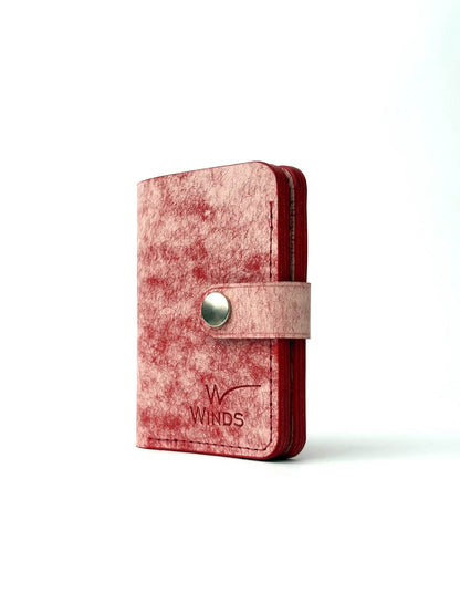 red glance bifold wallet with strap, rotated front edge view closed with Winds logo