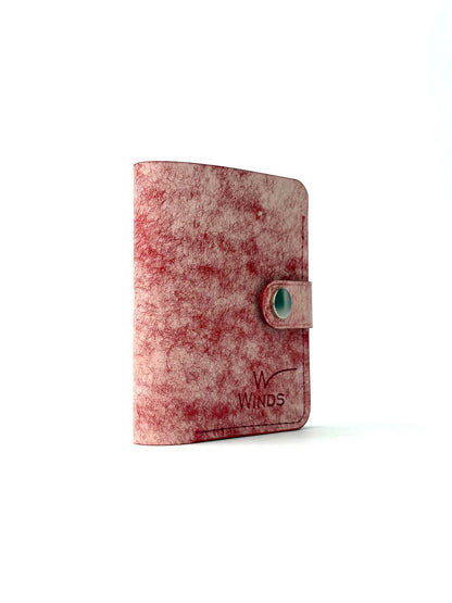 red glance bifold wallet with strap, rotated front view closed with Winds logo